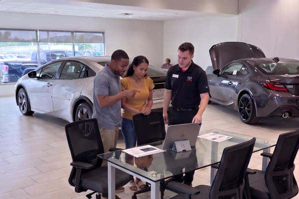 Couple reviewing purchase with Toyota advisor