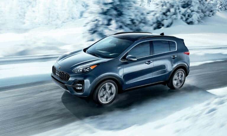 2021 Kia Sportage driving on a snowy road
