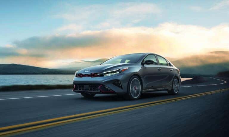 2022 Kia Forte Driving On Open Road At Dawn