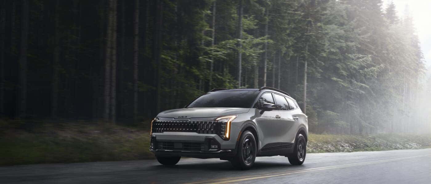 2026 Kia Sportage Exterior Driving On Forest Road