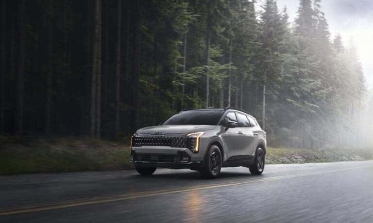 2026 Kia Sportage Exterior Driving On Forest Road