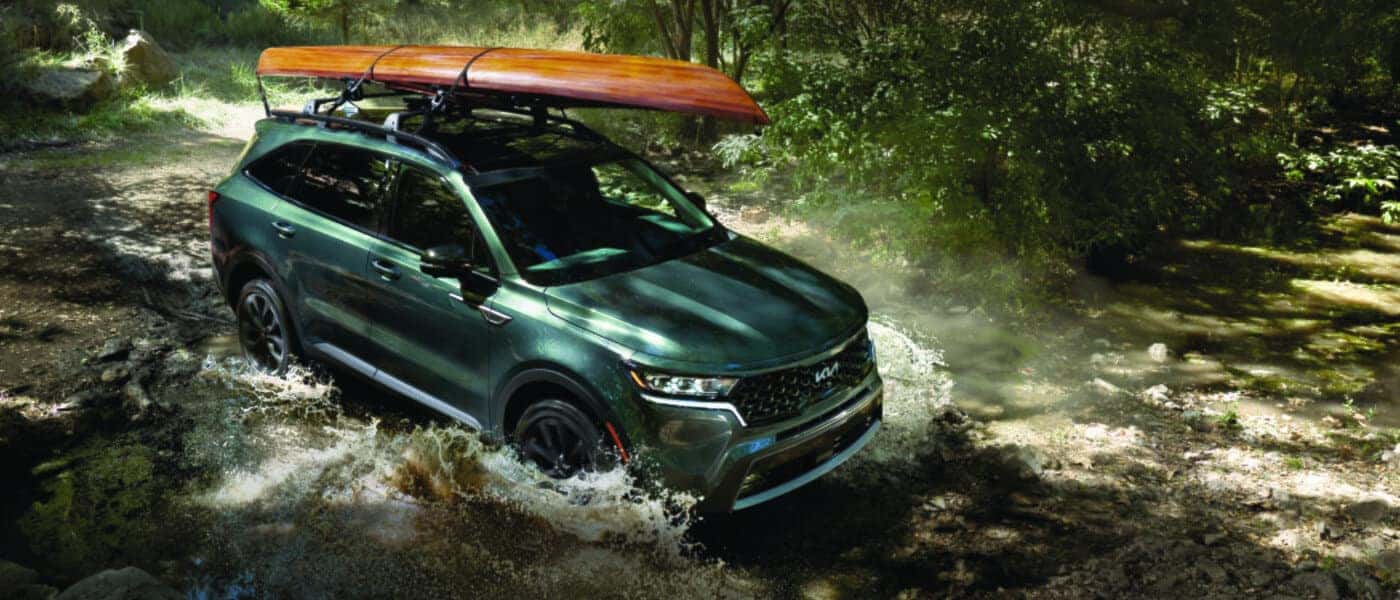 2026 Kia Sorento Exterior Driving Through Stream With Kayak