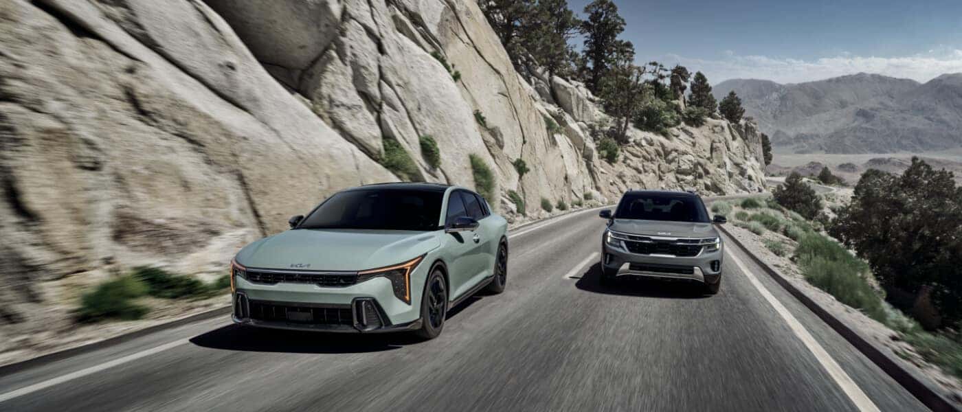 2026Kia-K4-ExteriorTwoDrivingInMountains