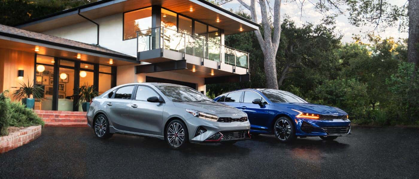 2026Kia-K5-ExteriorTwoParkedByHouse