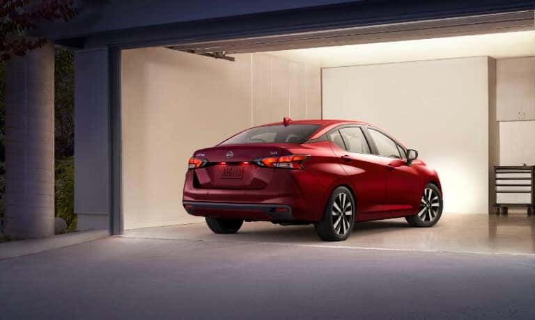 2020 Nissan Versa Exterior in red showing the back of the car Parked In A Garage