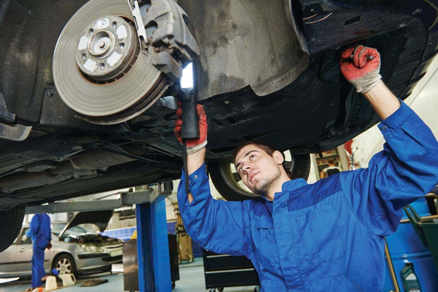 A mechanic inspecting brakes