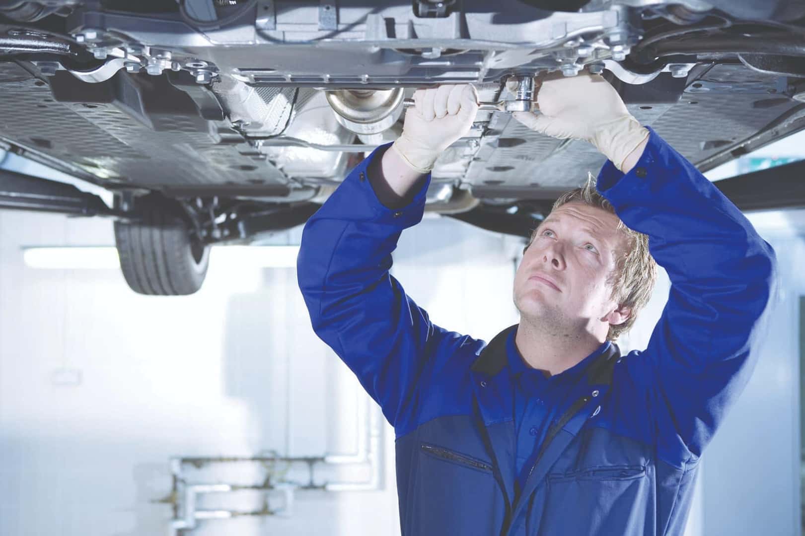 Mechanic working under a car