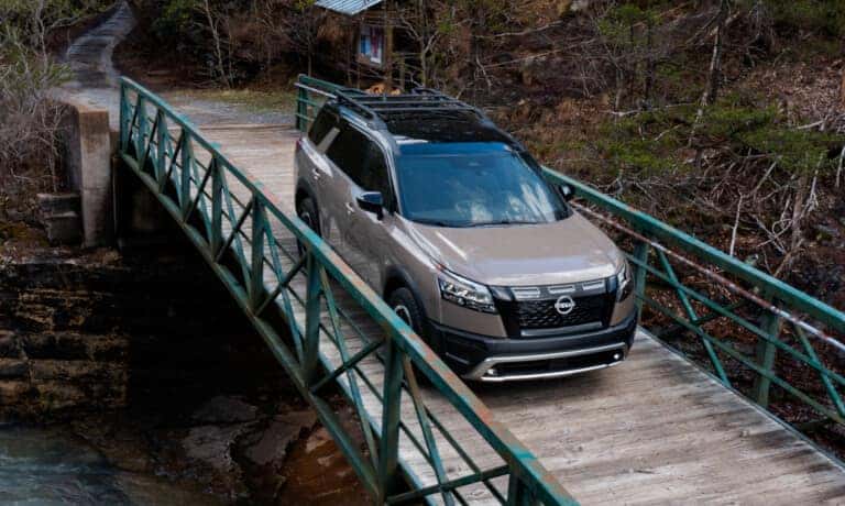 2023 Nissan Pathfinder Rock Creek Exterior Driving On A Bridge