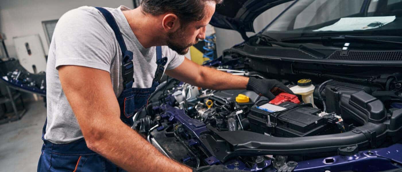 Service Inspection Technician Inspecting Under Hood