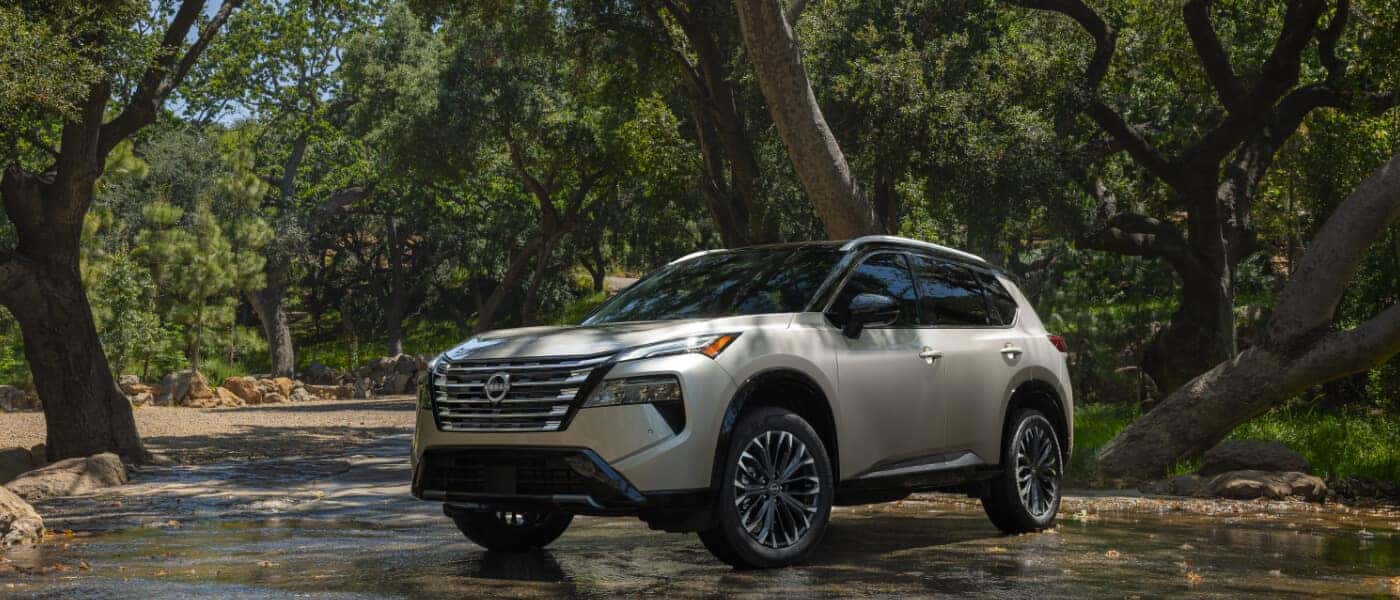 2025 Nissan Rogue Exterior Driving Through Forest