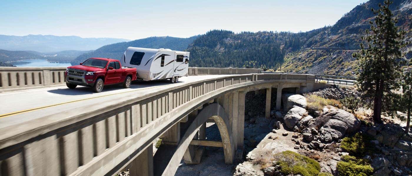 2025 Nissan Frontier Exterior Driving On Bridge Pulling Camper