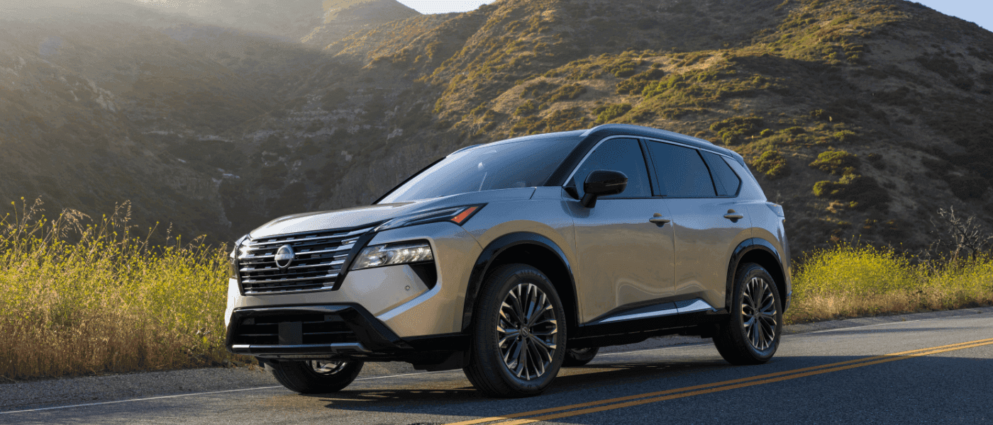 2026 Nissan Rogue Exterior Driving By Grassy Hills
