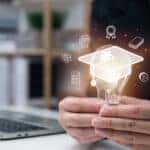 E-learning graduate certificate program concept, businessman hand holding light bulb with Internet education course degree, study knowledge, creative thinking idea, problem solving solution