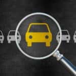 illustration of magnifying glass over a row of car icons