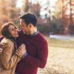 Happy couple at public park in autumn