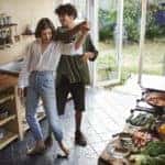 Shot of a young couple dancing while cooking together at home