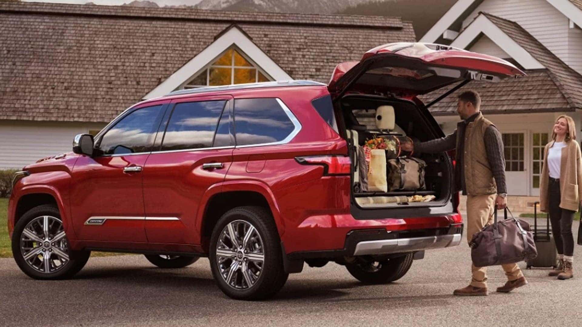 2025 red toyota sequoia with family packing trunk