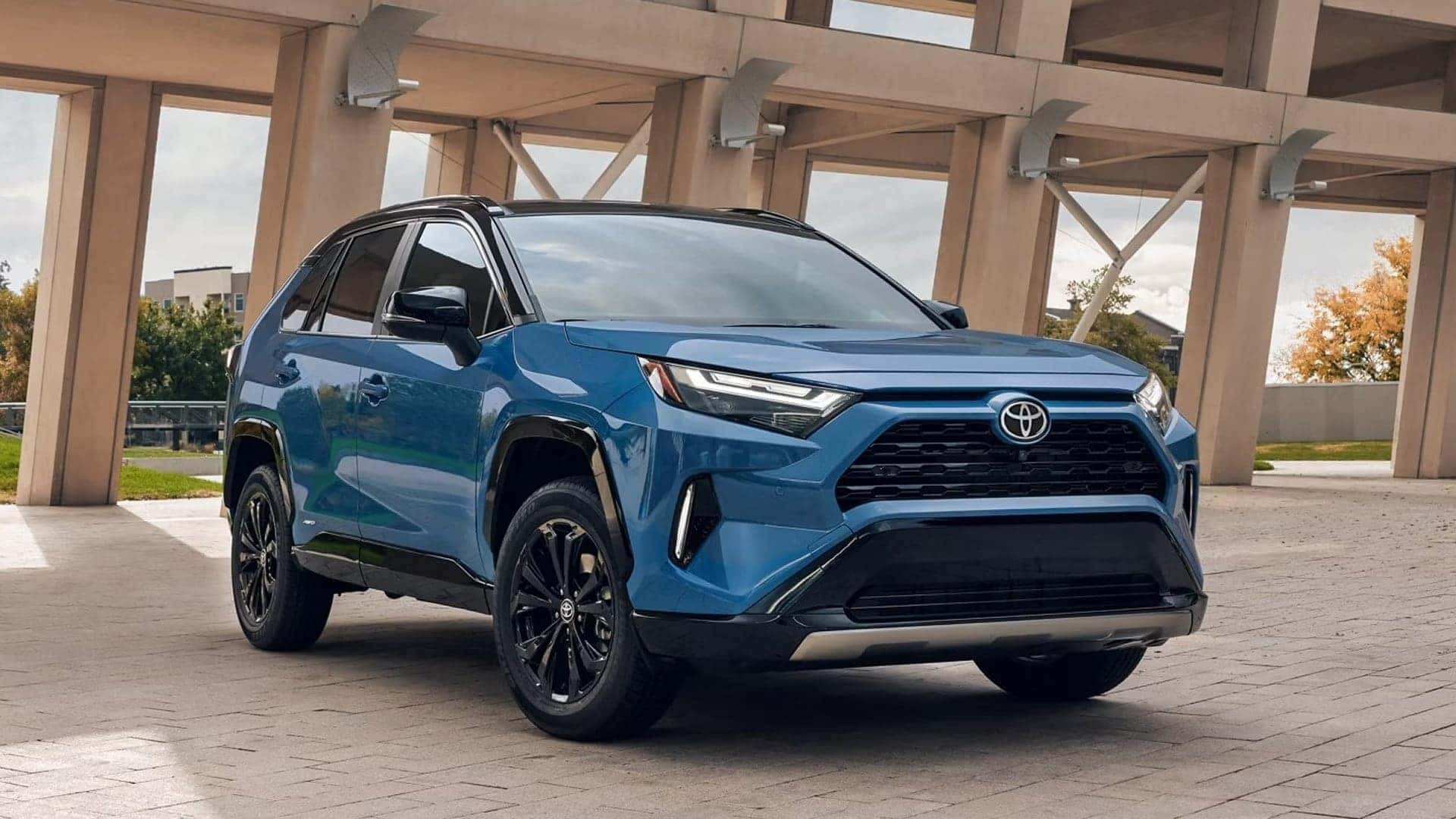 2025 blue toyota rav4 hybrid parked