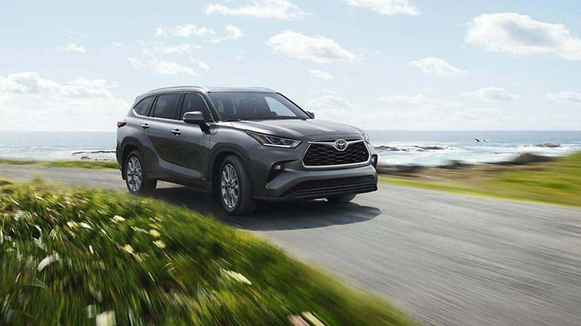 2025 toyota highlander driving on road