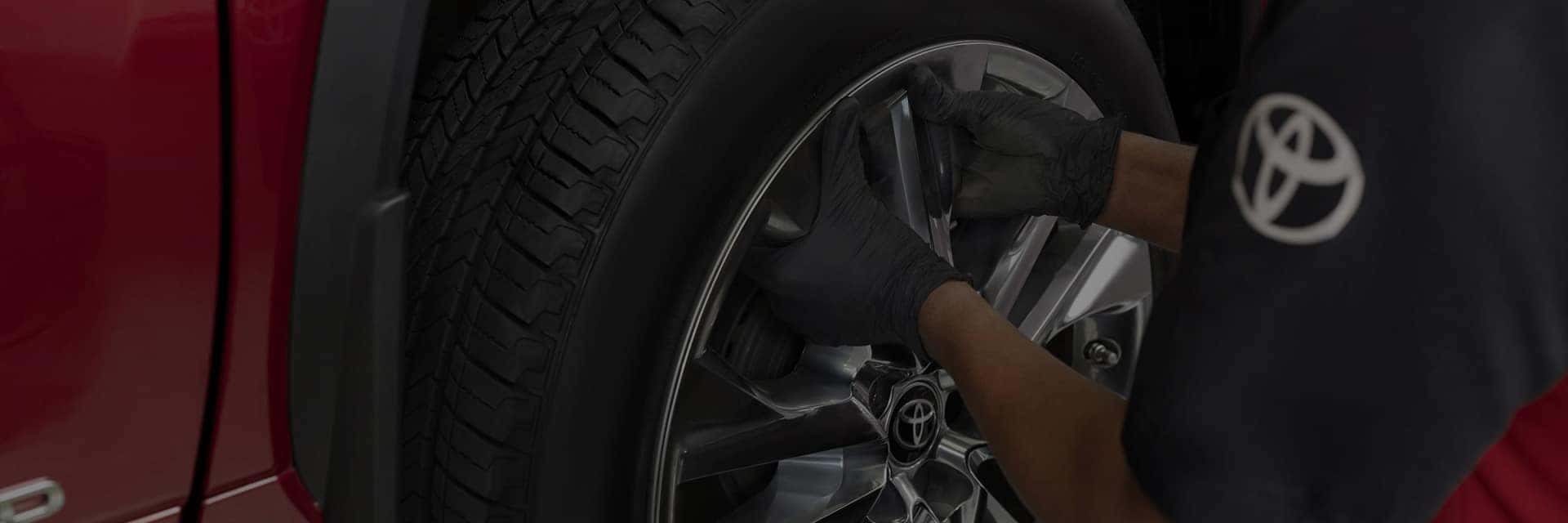toyota service technician working on tire