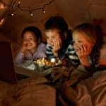 kids watching movie in tent