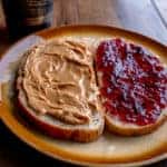 Open Face Peanut Butter and Jelly Sandwich on a Rustic Cutting Board on Artisan Multi-Grain Bread