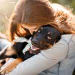 Girl hugging her dog