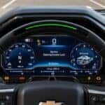 A Chevrolet instrument cluster showing a Service Steering Column Lock message, with warning icons along the bottom of the display