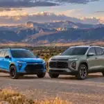 Chevrolet Trax and Chevrolet Equinox parked side by side on a gravel overlook with mountains behind them