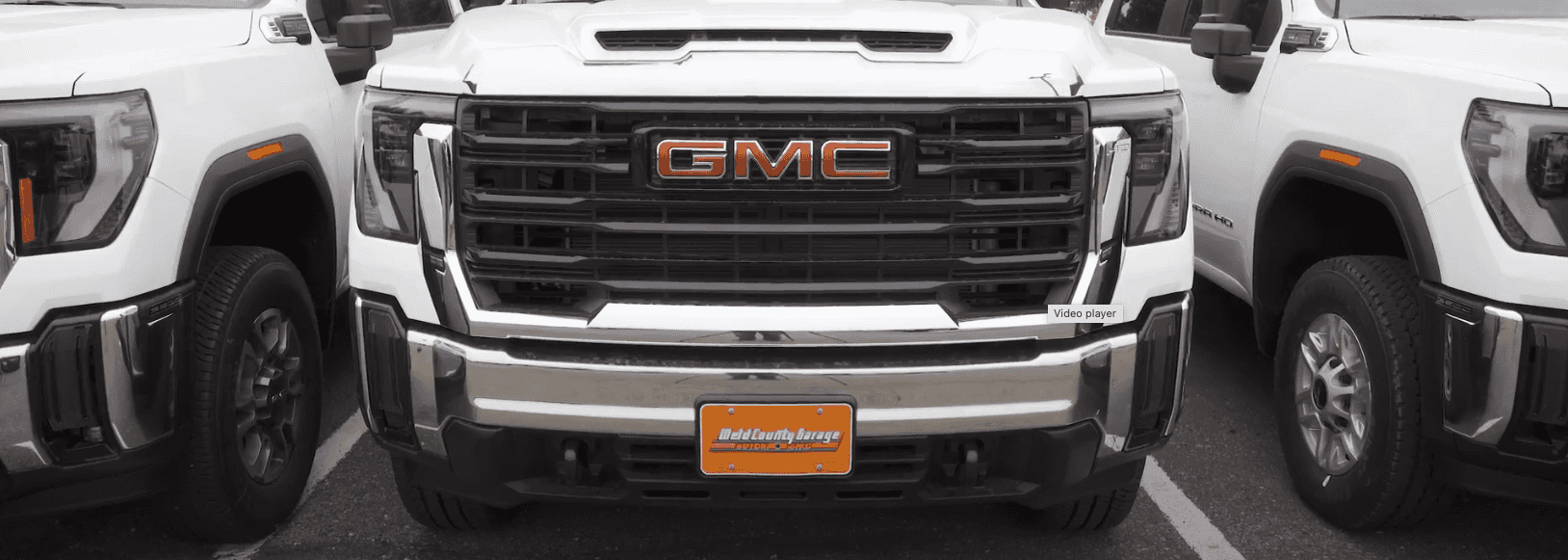 A couple of trucks parked in a construction field.