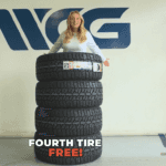 A set of four brand-new tires prominently displaying a 'Buy 3, Get 1 Free' offer in a clean, modern tire shop