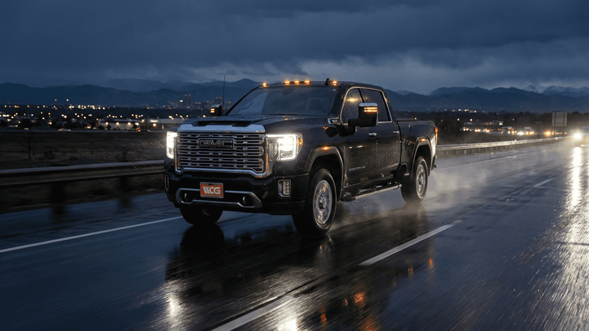 GMC Sierra 2500HD on wet Colorado highway at night