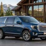 2026 GMC Yukon XL Denali Ultimate in front of an ultra-luxury mountain estate and ski resort in Colorado