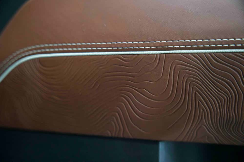 Embossed leather console detail with contrast stitching in the Sierra 1500 Denali Ultimate