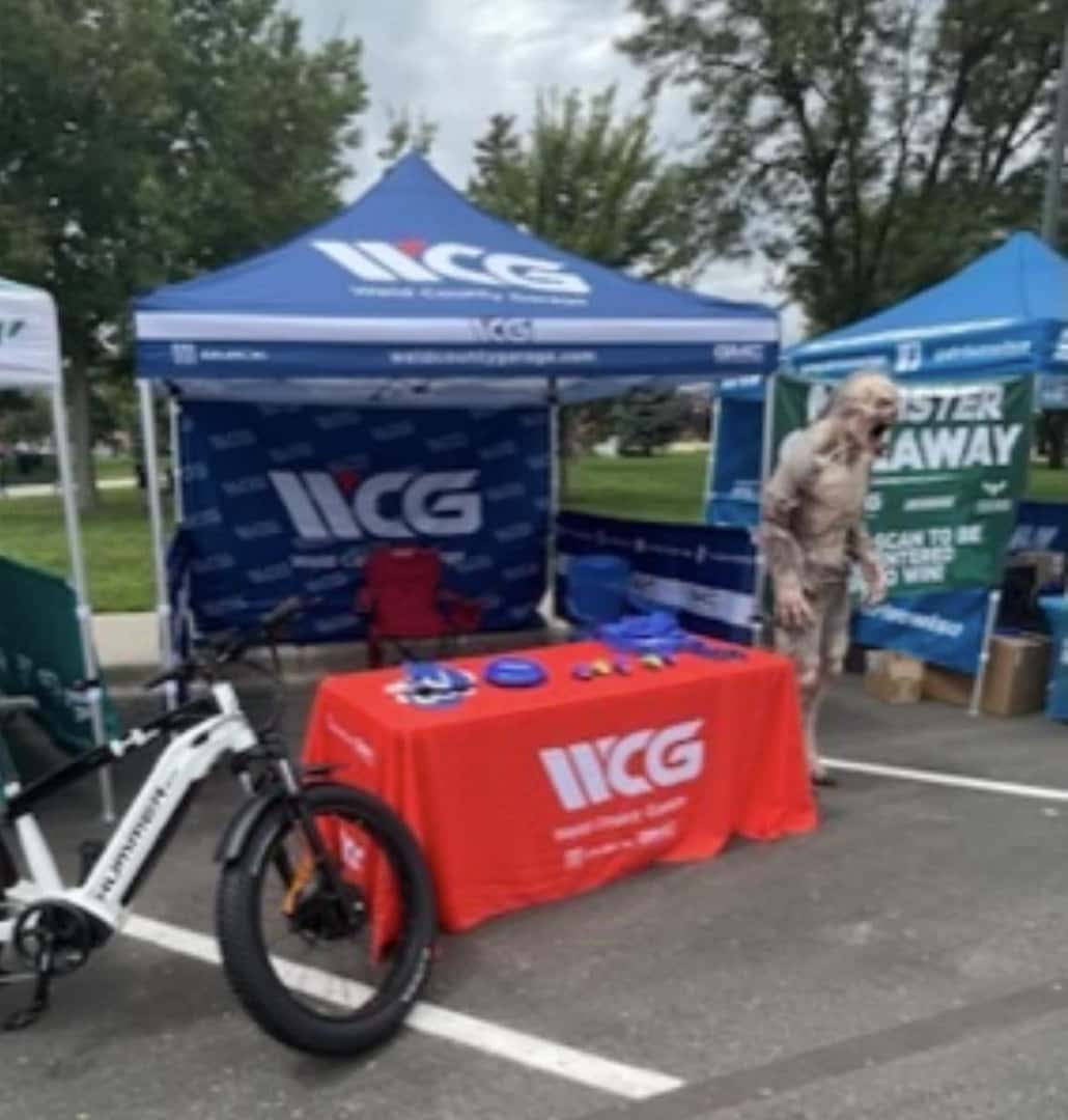 Weld County Garage GMC booth at Monster Day Greeley with GMC trucks on display in Downtown Greeley