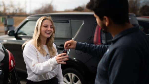 Seller handing over car keys at Weld County Garage in Greeley, CO